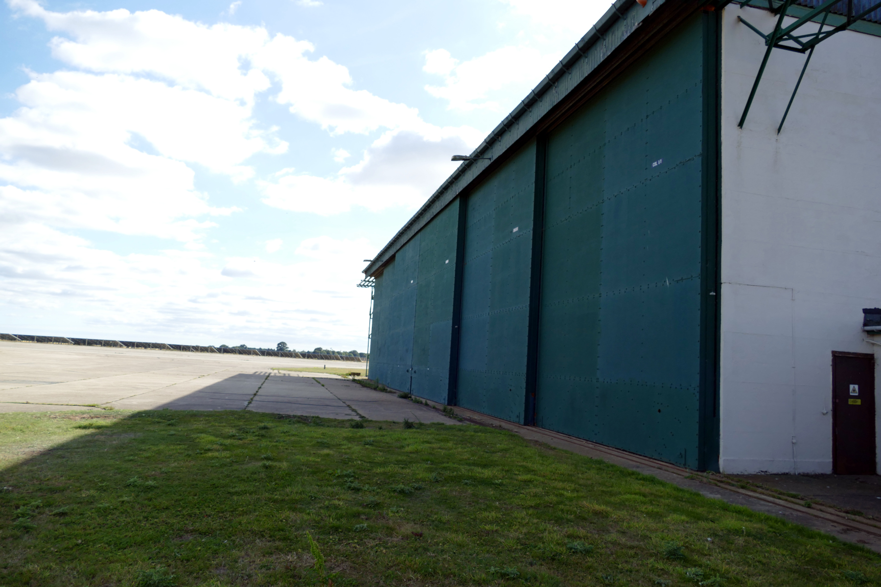 Exterior of original RAF aircraft hangar with large green wall